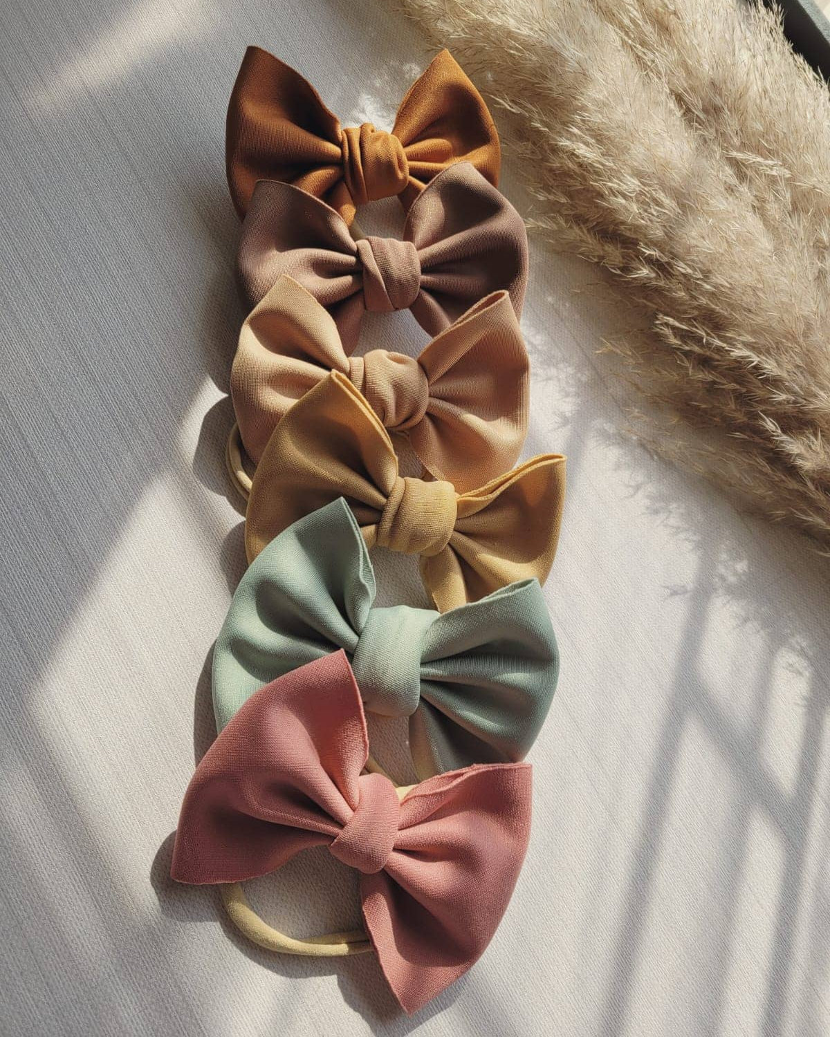 Set of colorful hair bows on a textured surface