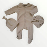 Beige baby onesie with matching hats on a white background