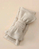 Folded textured fabric on a beige background