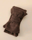 Folded brown fabric on a beige background