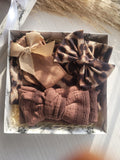 Set of decorative bows in a box on a marble surface
