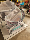Baby bassinet with canopy on display in a store setting