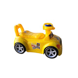 Yellow toy police car on a concrete floor with a television screen displaying children's content in the background.