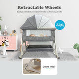 Gray baby crib with retractable wheels in a room setting