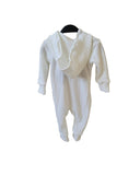 White baby romper with ruffled collar hanging on a crib