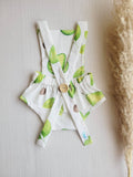 Baby outfit with avocado print on a neutral background