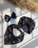 Black hair accessories with Chanel logo on a white surface