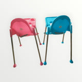 Pink and blue children's high chairs on a white background