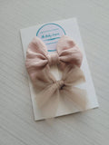 Two pink hair bows on a card with 'The Baby Empire' branding on a light gray background.